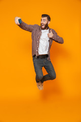 Full length portrait of a cheerful young man