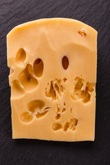 Piece and slices of cheese on a white background