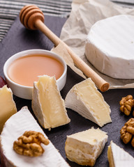 delicious creamy camembert cheese on a wooden rustic background