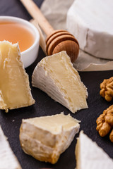 delicious creamy camembert cheese on a wooden rustic background