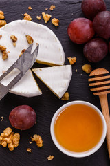 delicious creamy camembert cheese on a wooden rustic background