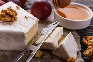 delicious creamy camembert cheese on a wooden rustic background