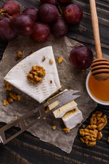 delicious creamy camembert cheese on a wooden rustic background
