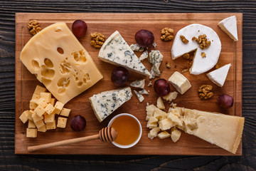 set of different cheeses on a wooden rustic background