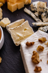 set of different cheeses on a wooden rustic background