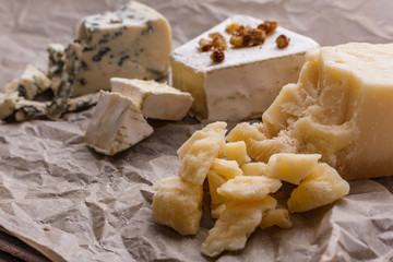 set of different cheeses on a wooden rustic background