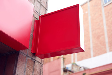 Squared red front store signboard mock-up on building wall outdoor..