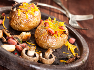 Baked stuffed potatoes with bacon, cheddar, mushrooms and dill