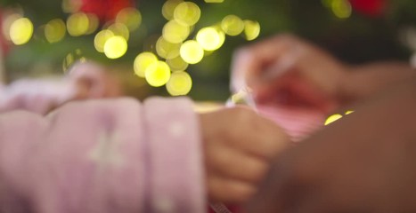 Child Unwrapping Present Close Up