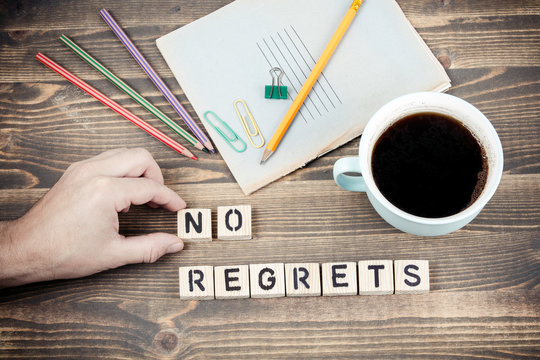 No Regrets. Wooden letters on the office desk, informative and communication background