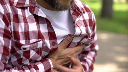 Middle-age male feeling strong chest pain, sensation of tightness, heart attack