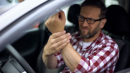 Automobile driver feeling wrist pain, joint inflammation, osteoarthritis, health