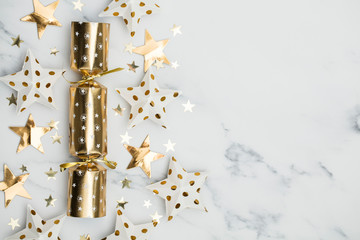 Christmas crackers. luxury gold festive cracker on a marble background