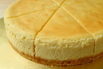 Closed up a delectable creamy yellow color whole baked cheesecake