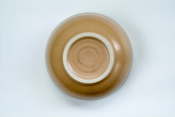  the circle from the bottom of the beige ceramic is isolated in white