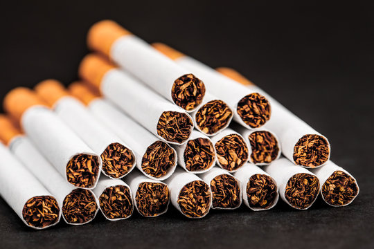 Close-up of tobacco cigarettes on a black background