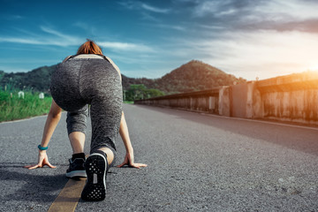 Asian woman is workout and running at the morning, she is warm up her body and drinking water. Healty and sport lifestyle concept.