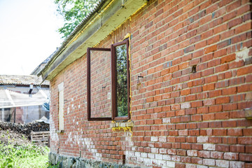 Renovation of old red brick house: roof and window are sprayed with liquid insulating foam. Self made construction.