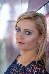 Portrait of a young blonde Caucasian woman with an abstract background