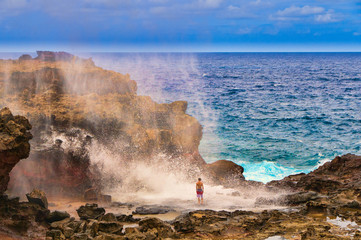 Tourists looking at a blow hole on Maui, Hawaii, USA