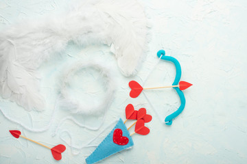 Background of lovers, arrows and cupid bow on a light background. Valentine's Day. Flat-lay, top view
