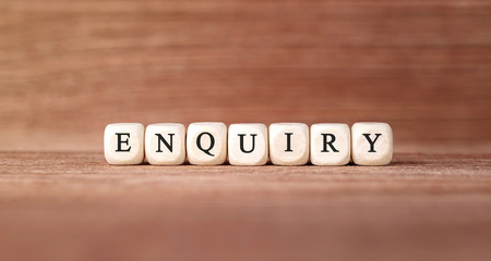 Word ENQUIRY made with wood building blocks