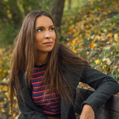 Portrait of beautiful young girl in picturesque autumn park.