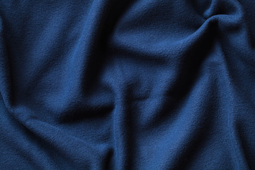 Fototapeta na wymiar Wavy texture of blue fleece fabric