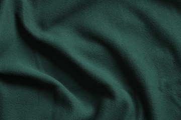 Texture of dark green fleece, soft fabric