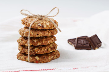 oatmeal cookies, honey and chocolate on white background. Rustic style.