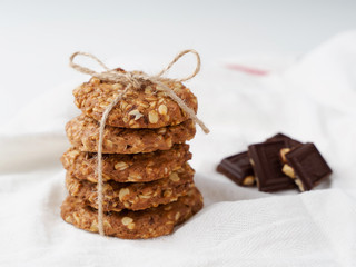 oatmeal cookies, honey and chocolate on white background. Rustic style.