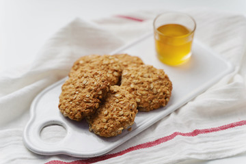 oatmeal cookies, honey and chocolate on white background. Rustic style.