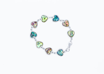 metal bracelet made with heart shaped multi colored  stones inset in silver metal settings