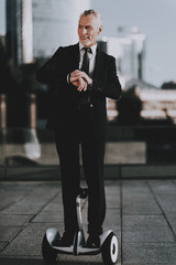 Businessman is Looks a Time on Clock on Gyroboard © Vadym Huzhva