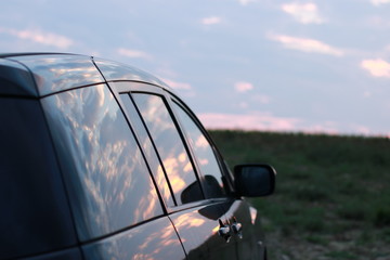 sky and clouds relecting on car