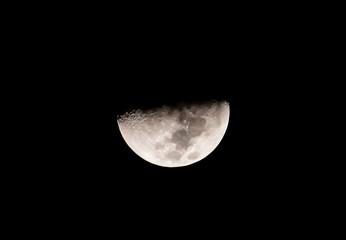 Half moon on black sky background.