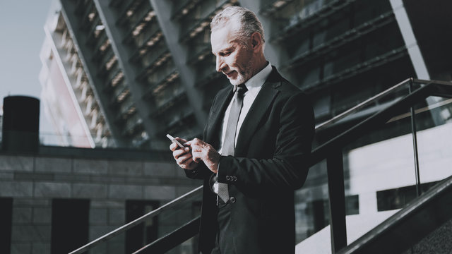 Businessman is Using a Mobile Phone