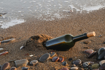 Wine bottle on a sandy beach