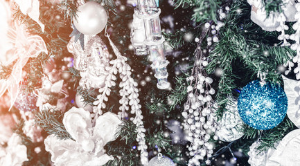 Christmas tree background and Christmas decorations with snow, blurred, sparking, glowing. Happy New Year and Xmas theme