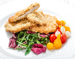 Grilled chicken breasts with sesame, salad with cabbage fat and rucola on light wooden background. Hot Meat Dishes