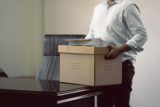 Businessmen or employees holding boxes with documents. It means moving out of work or moving up. as background business concept and moving out concept with copy space.