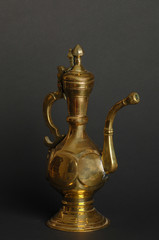 Fototapeta na wymiar ancient oriental metal teapot on dark background. antique bronze tableware