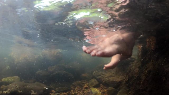 Bare foot soak in the waterfall to adjust body temperature at Wang Takrai Waterfall in Nakhon Nayok Province, Thailand.