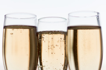 a few glasses of champagne on a white background