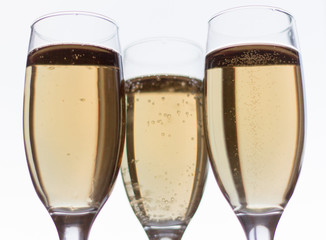 a few glasses of champagne on a white background