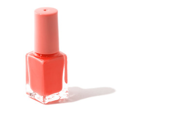 Trend photography on the theme of the actual colors for this season - a shade of orange.  Isolated purple nail bottle on a white background.