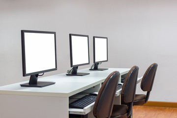 Row of three white screen monitors on desk with keyboard.selective focus Image with copy space.Clipping Path image.