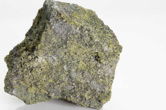 Vesuvianite, also known as idocrase, is a green, brown, yellow, or blue silicate mineral from Vesuvius volcano, isolated on a white background, Naples, Italy
