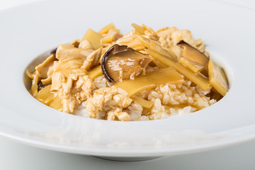 White plate of hot asian food with rice and meat