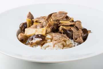 Plate of asian food with rise, mushrooms and meat
